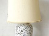 a lamp that is sitting on a table with a lamp shade on it