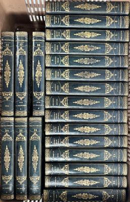 several old books are stacked on top of each other in a box