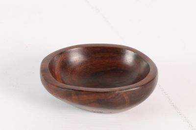 wooden bowl on a white surface with a white background