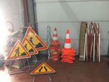 a pile of construction signs and cones on the floor