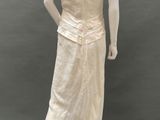 an image of a mannequin wearing a white dress and hat