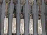 a lot of forks and spoons that are on a table