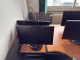 a desk with two monitors and a keyboard on it