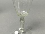 a wine glass that is sitting on a table