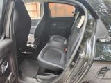 a black car with the door open and the seats down