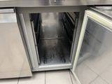 an open door in the middle of a stainless steel kitchen