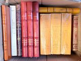 many books in a cardboard box on a table