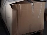 a cardboard box sitting on a pallet in a garage
