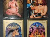 three books of erotic comics are on display on a black surface