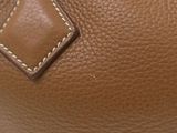 the inside of a brown leather purse with a white stitching on it