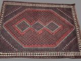 a red and black rug with a diamond design on it