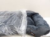a bag of clothes wrapped in plastic sitting on a table