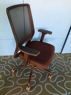 a brown office chair with a brown seat on a carpet