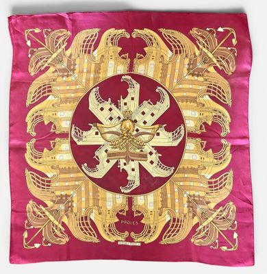 an image of a red and gold square scarf with a gold design