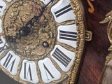 a close up of a clock with a face on it