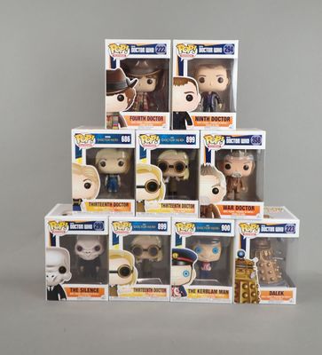 a stack of six pop vinyl figures of the doctor and his companions