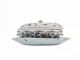 an image of a white bowl with a lid and a plate on it