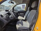 a yellow truck with a black seat in the back of it