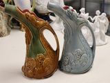 two vases that are sitting on a table