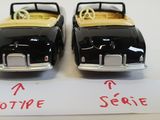 pair of black and yellow toy cars sitting on top of a white table