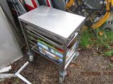 a metal table with magazines on it next to a pile of bikes
