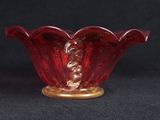 an image of a red glass bowl on a black background