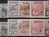 four different stamps of different colors and sizes on a black surface
