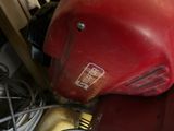 a red blender sitting on top of a pile of wires