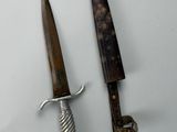 two knives that are sitting next to each other on a table