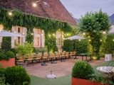 a patio with tables and umbrellas in the middle of it
