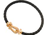 a black leather bracelet with a gold clasp on a white background