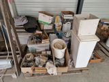 a pile of junk on a pallet in a garage
