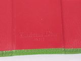 leather wallet with a red and green cover on a white surface