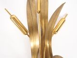 a gold vase with a plant in it on a table
