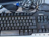 a computer keyboard and a monitor on a desk