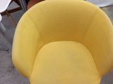 a yellow chair that is sitting in the middle of a room
