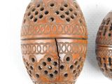 two decorative objects that are sitting on a white surface