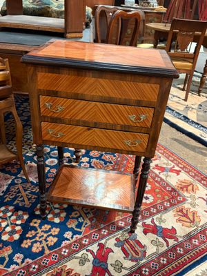 a small wooden table with a drawer on top of it