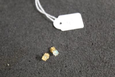 a small piece of paper on the ground next to a tag
