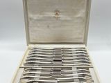 a set of silverware in a wooden box with a handle