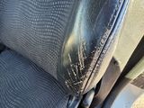 a close up of a seat in a car with the arm rest down