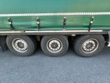 a close up of a green semi truck with four tires