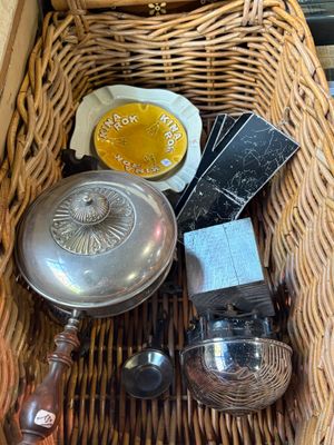 a wicker basket filled with silverware and other items