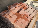 a pile of bricks sitting on the ground next to a pile of other bricks