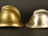 two helmets sitting next to each other on a black surface