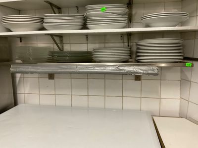 a lot of plates and bowls on the shelves in the kitchen