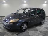 a picture of a grey car parked in a garage