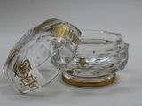a small glass bowl with a lid on a white surface