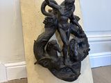 an image of a sculpture of a woman and a man on a rock