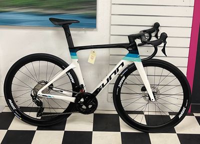 a bike that is sitting on a checkered floor